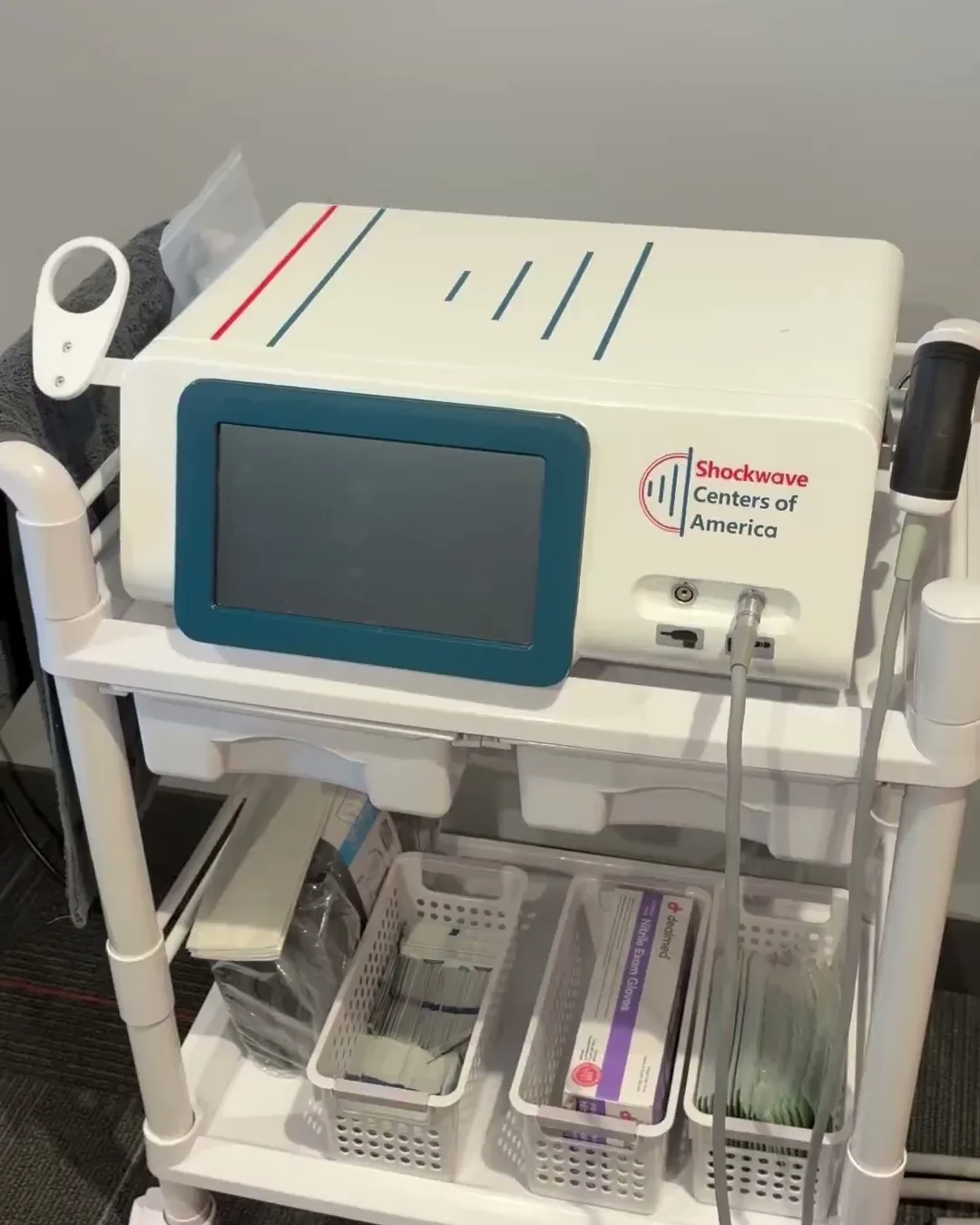 Shockwave therapy unit on its cart at the Oceanside office